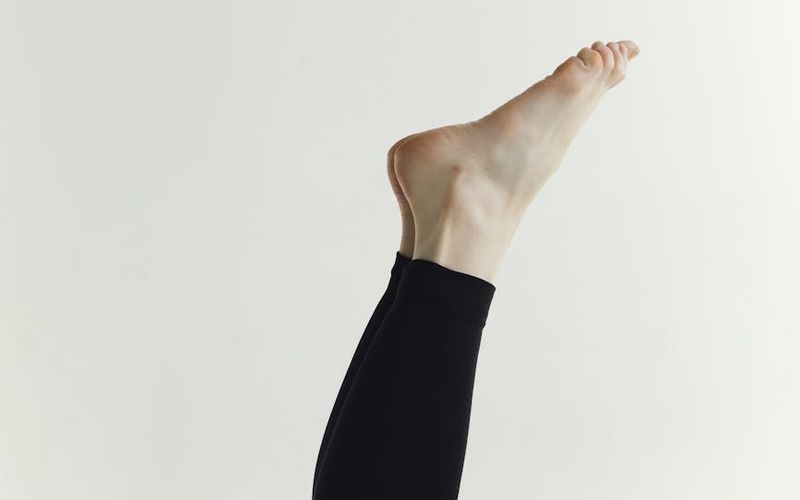 Person moving gracefully in a well-lit minimalist studio.